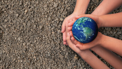 Group of Hands holding earth globe on blue background, International human solidarity day concept,...