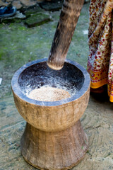 Pesting beans in a Ukhal musal (Mortal and Pestle)