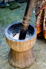 Pesting beans in a Ukhal musal (Mortal and Pestle)