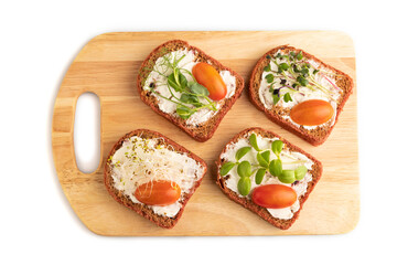 Red beet bread sandwiches with cream cheese, tomatoes and microgreen isolated on white. top view.
