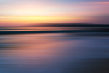 Fototapeta premium Beautiful sunset background at the beach motion blur