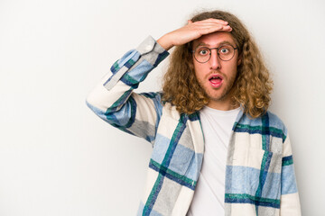 Young caucasian man isolated on white background looking far away keeping hand on forehead.