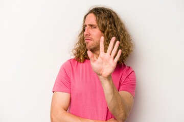Young caucasian man isolated on white background rejecting someone showing a gesture of disgust.