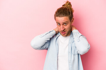 Young caucasian man isolated on pink background touching back of head, thinking and making a choice.