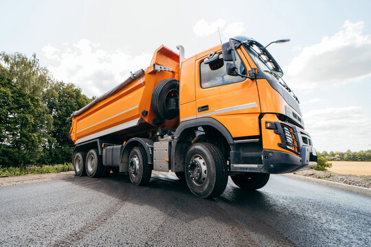 Dumper truck ready to unload soil or groud at construction site. Road service build a new highway	
