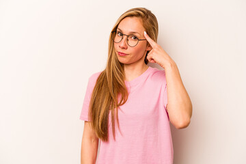 Young caucasian woman isolated on white background pointing temple with finger, thinking, focused...