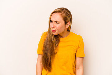 Young caucasian woman isolated on white background shrugs shoulders and open eyes confused.