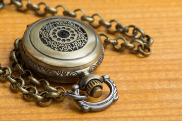 Vintage pocket watch on a table.