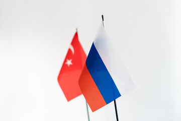 State flags of Russia and Turkey on white background. Selective focus on russian flag