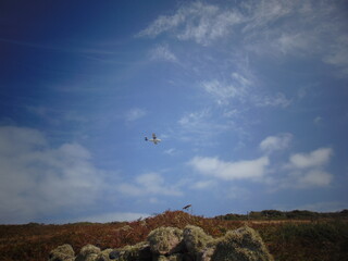Fototapeta na wymiar Plane flying in the sky, The Scilly Isles (St Martins)