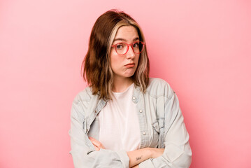 Young caucasian woman isolated on pink background unhappy looking in camera with sarcastic expression.