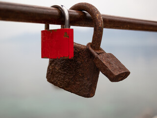 old rusted padlock hanging on iron