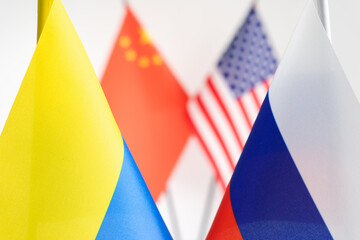 State flag of Russia and Ukraine. China USA flags on background. Russian Ukrainian war conflict