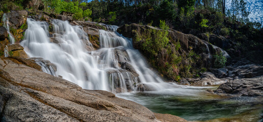 view of the Cascata Fecha de Barjas waterfalls in the Peneda-Geres National Park in Portugal