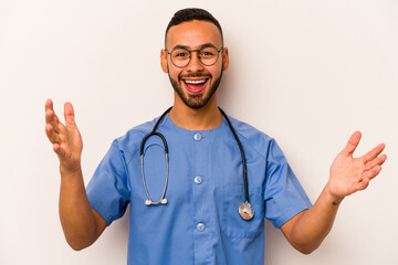 Young hispanic nurse man isolated on white background receiving a pleasant surprise, excited and...