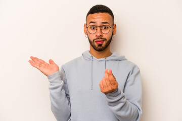 Young hispanic man isolated on white background showing that she has no money.
