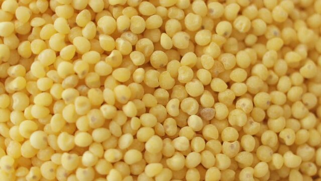 Close up of dry spilled millet rotating. The view from the top