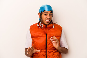 Young African American man isolated on white background rejecting someone showing a gesture of disgust.