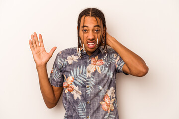 Young African American man isolated on white background screaming with rage.