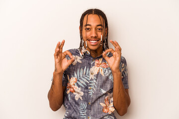 Young African American man isolated on white background cheerful and confident showing ok gesture.