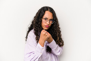 Young hispanic woman isolated on white background showing fist to camera, aggressive facial expression.