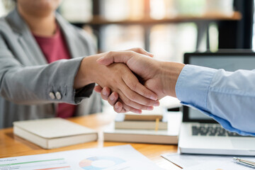 Business negotiation concept the estate representatives shaking hand each other to agree with the...