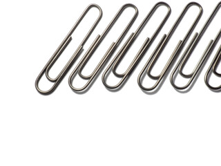 Metal paper clips on a white background. office supplies.  isolated