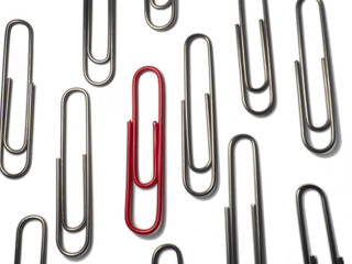 Metal paper clips on a white background. Office supplies isolate. Idea. The concept of loneliness. Confrontation. Stands out from the crowd.