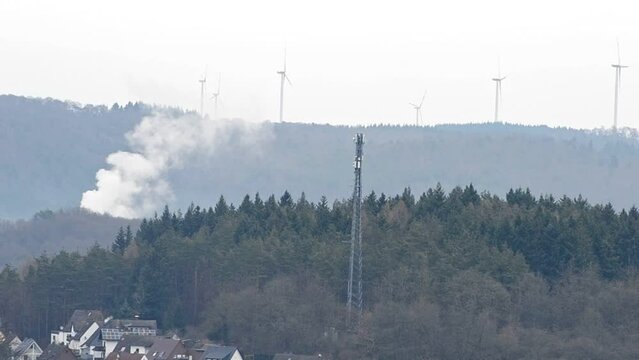 Small forest fire in the hills around Herborn, Germany. Static wide angle shot