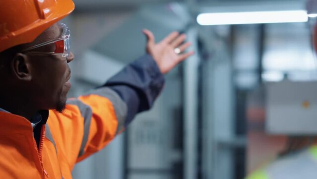 Closeup uniformed engineer talking unknown specialist at manufacture company
