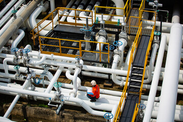 Top view male worker inspection at valve of visual check record pipeline oil