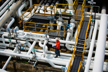 Top view male worker inspection at valve of visual check record pipeline oil