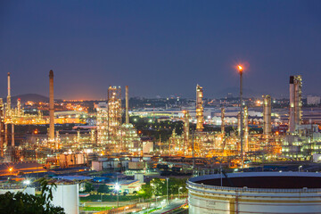 Fototapeta na wymiar Tank crude oil scene of refinery plant and tower column of evening​ sunset Petrochemistry industry