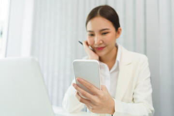 Fototapeta premium Confidence woman concept, Businesswoman use smartphone to checking data for analyzing strategy