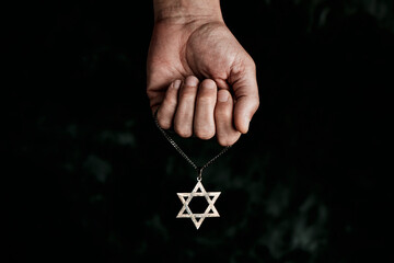 man with a pendant in the shape of the star of david
