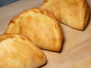 National bakery. A pie with cabbage. Pies with stuffing on the table. Cuisine of the countries of the world.