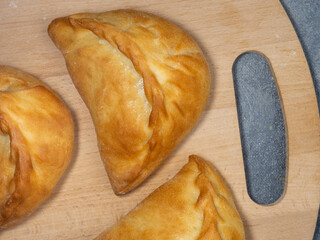 National bakery. A pie with cabbage. Pies with stuffing on the table. Cuisine of the countries of the world.