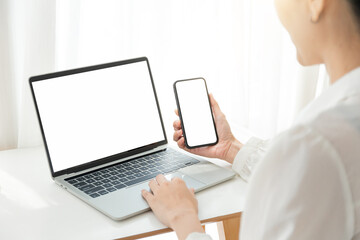 computer screen,cell phone blank mockup.hand woman work using laptop texting mobile.white background for advertising,contact business search information on desk in cafe.marketing,design