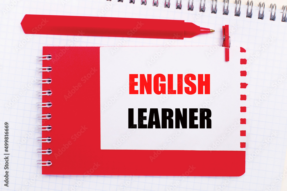 Poster on a white notepad, a red pen, a red notepad and a white sheet of paper with the text english learne