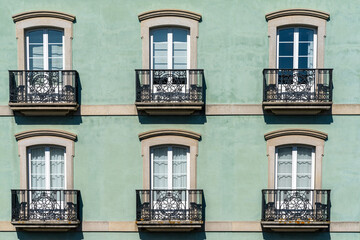 close-up view of house front with French doors and small balconies
