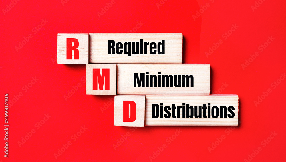 Poster on a bright red background, wooden cubes and blocks with the text rmd required minimum distributions