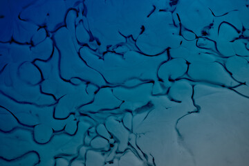 An art image with blue paint effects and milk creating abstract background. Ideal as wallpaper, background ,advertising etc., 