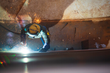 Top view Gouging welding spark fire industrial welder wear safety protective mask construction repair tank oil weld