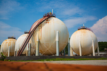 White spherical propane tanks containing fuel gas