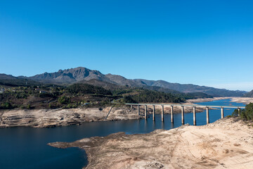 view of the bridge crossing the almost emtpy Alto Lindoso Reservoir