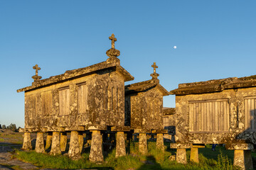 Fototapeta na wymiar evening light over granaries and stone storage sheds in the village of Lindoso in Portugal