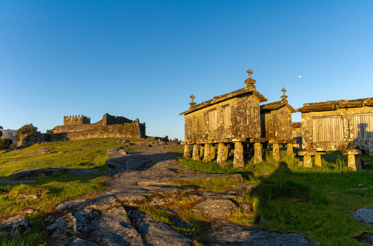 Lindoso Castle and historic stone granaries in the village of Lindoso in Portugal in warm evening light