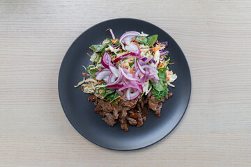 A plate of teriyaki beef salad.