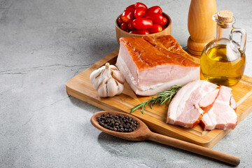 Sliced ​​raw bacon on the table.