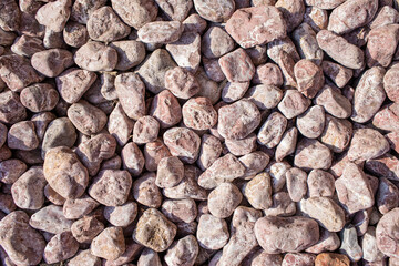 Small gray stones, lots of grey rocks on the ground top view, outdoors garden pavement high resolution material surface structure, walkway simple natural background texture, seen from above, nobody